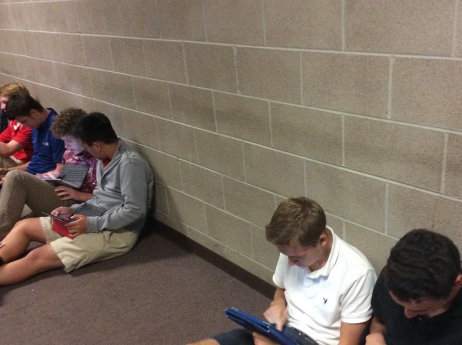 Regis+students+in+junior+hall+work+and+play+games+on+their+iPads.