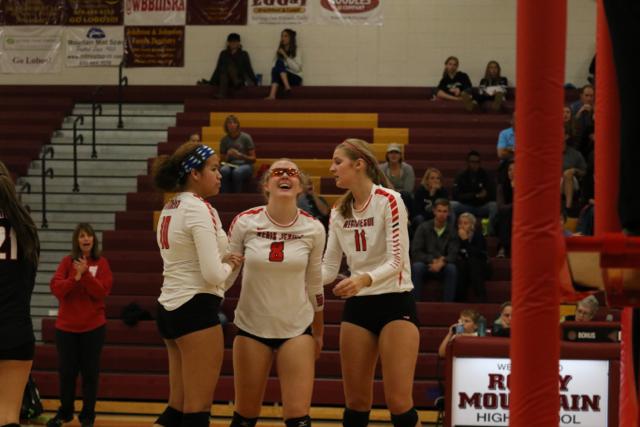 Senior Mary Raitt celebrates with juniors Alex Osredker and Kassandra Sturges.