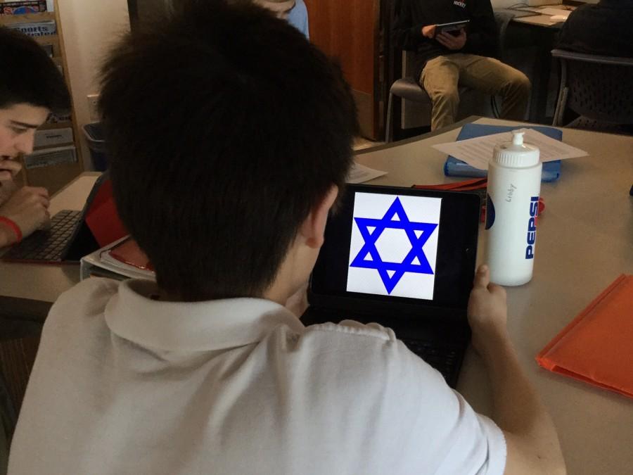 Student at Reigs Jesuit High School with picture of other religious symbol