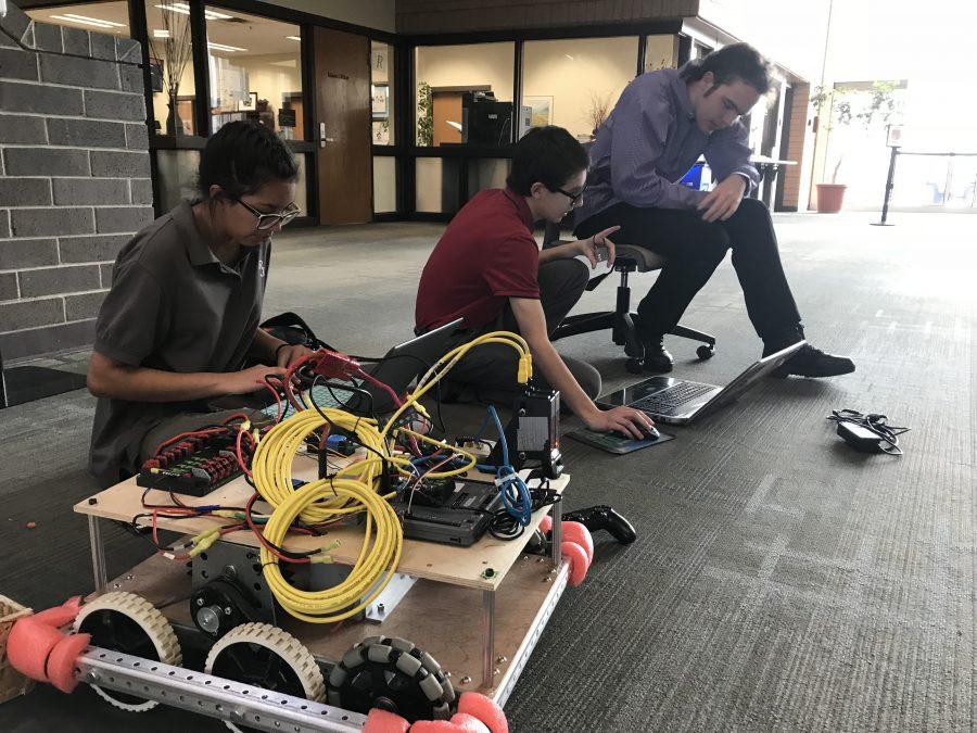 Sofia Reyes and other members of the RJ Robotics Club test this years competition robot during a club meeting after school.