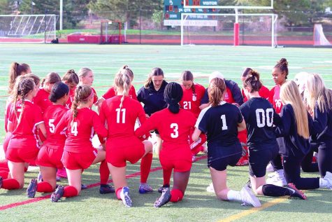 The Regis Girls Varsity Soccer team praying one last time at home before the game against Douglas County High School commences. 