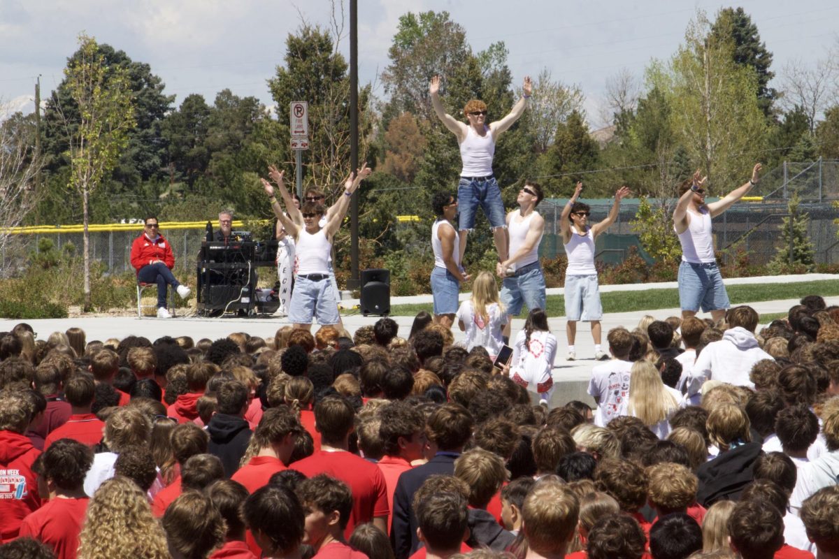 Senior guy poms celebrate their dance for Kash at the Wish Week pep rally. 