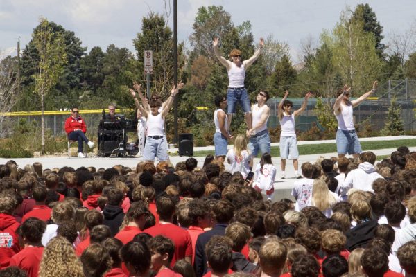 Senior guy poms celebrate their dance for Kash at the Wish Week pep rally. 