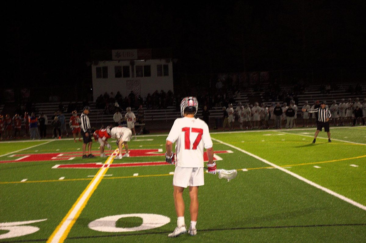 Max Hogan '27 watches the faceoff as he prepares for the ball to be in play. Photo by Braeden Baker