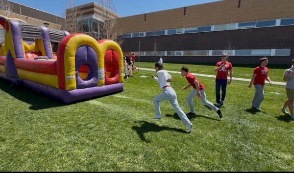 MiaBella Rodriguez ’28 takes off in a race against math teacher Mr. Gholston during field day. Photo by Nevaeh Waterman ‘28