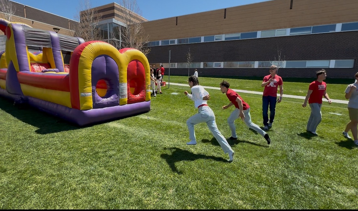 MiaBella Rodriguez ’28 takes off in a race against math teacher Mr. Gholston during field day. Photo by Nevaeh Waterman ‘28