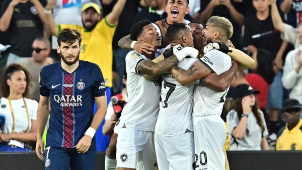 PSG's Khvicha  Kvaratskhelia walks by as Botafogo celebrate their goal vs. PSG. 
Photo via France 24